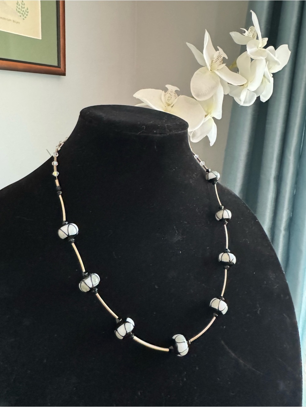 Black & silver geometric necklace featuring patterned spherical glass beads 22”